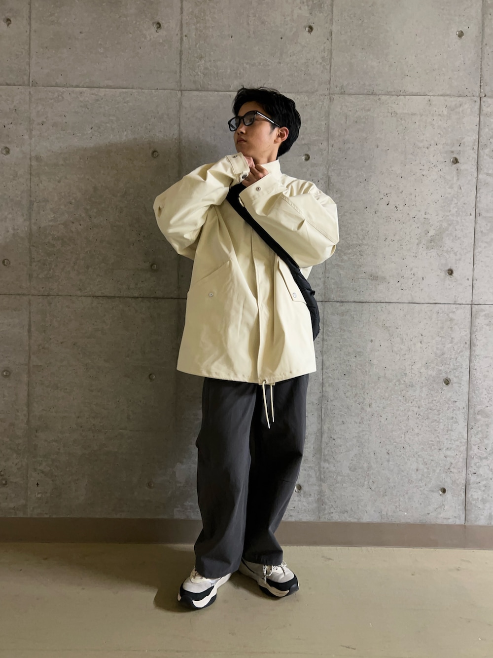 ホワイト系のミリタリージャケット、ブルー系のシャツ/ブラウス、ブラック系のショルダーバッグを着用したメンズの冬コーディネートの5枚目の写真