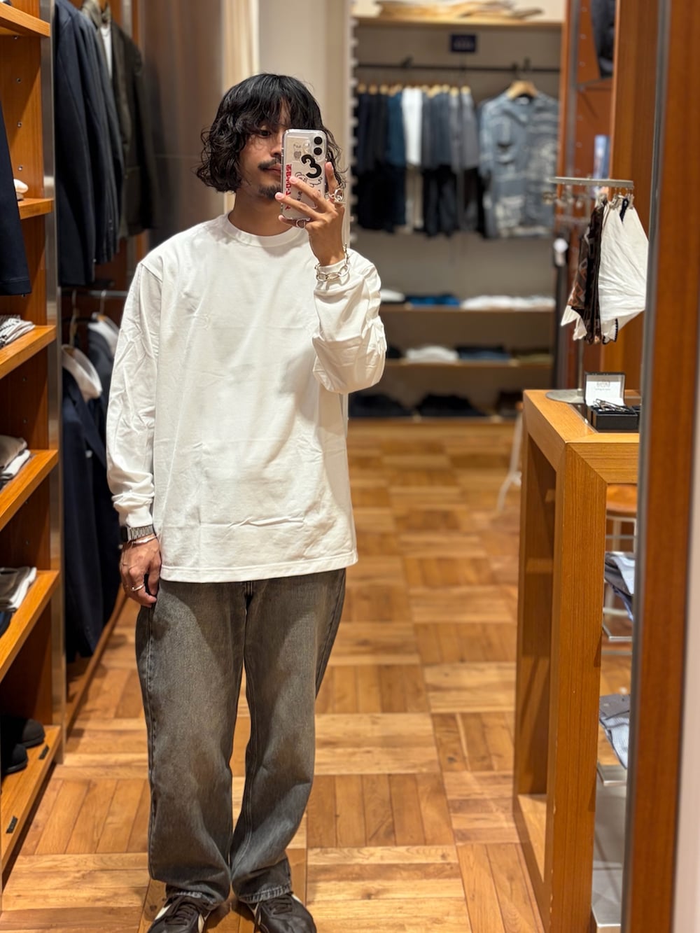 ホワイト系のTシャツ/カットソー、ブラック系のデニムパンツを着用したメンズの秋コーディネートの2枚目の写真