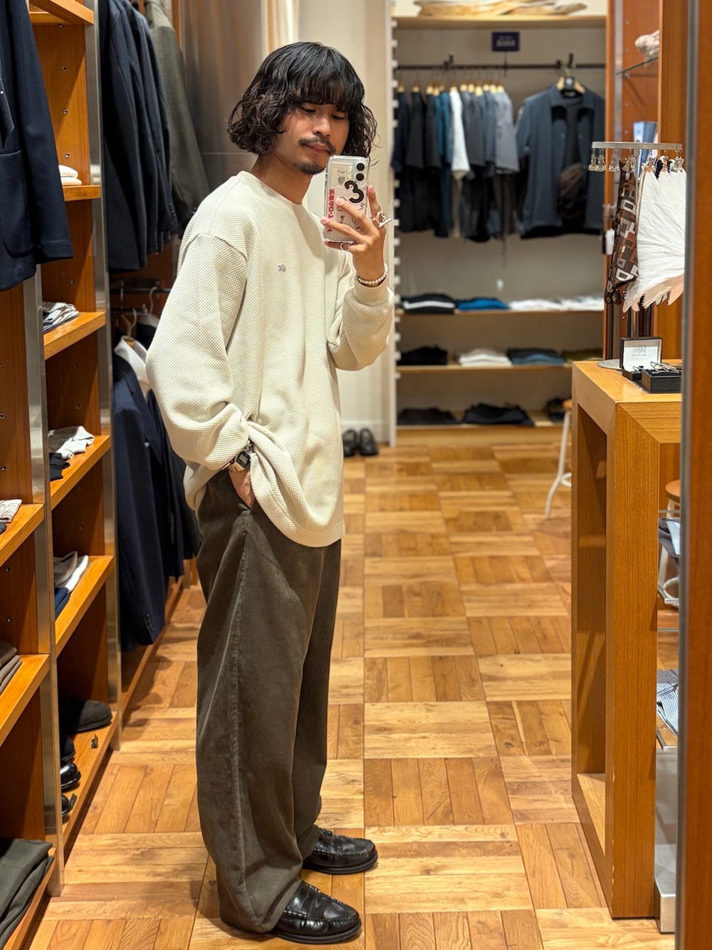 ホワイト系のTシャツ/カットソー、ブラウン系のその他パンツ、オレンジ系のトートバッグを着用したメンズの秋コーディネートの2枚目の写真