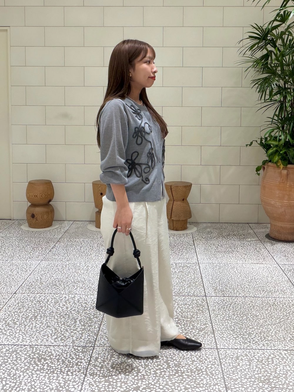 グレー系のカーディガン/ボレロ、ホワイト系のその他パンツ、ブラック系のその他シューズを着用したレディースの秋コーディネートの3枚目の写真