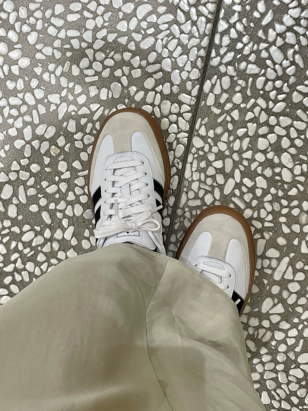 ホワイト系のスウェット、ブラウン系のブルゾン、ベージュ系のスカートを着用したレディースの冬コーディネートの4枚目の写真