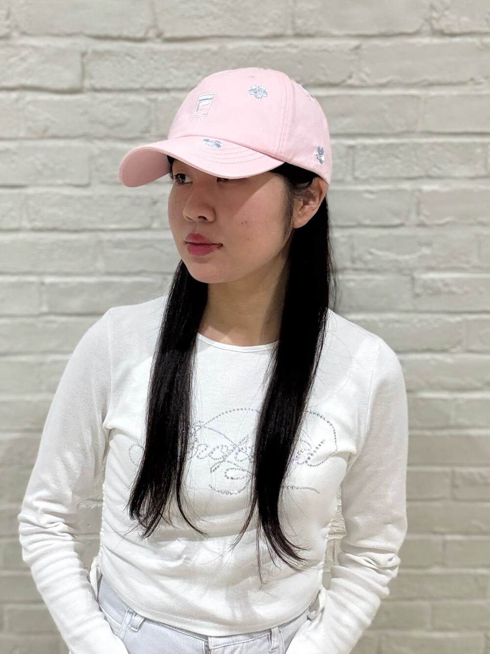 ホワイト系のTシャツ/カットソー、グレー系のデニムパンツ、ホワイト系のスニーカーを着用したレディースの春コーディネートの3枚目の写真