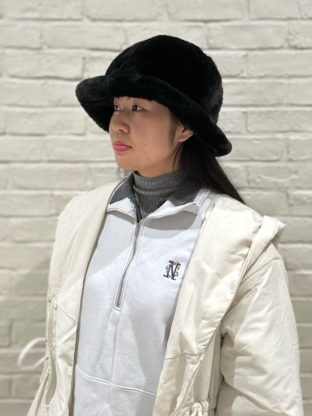 ホワイト系のダウンジャケット/コート、グレー系のニット/セーター、ブルー系のスウェットを着用したレディースの冬コーディネートの4枚目の写真