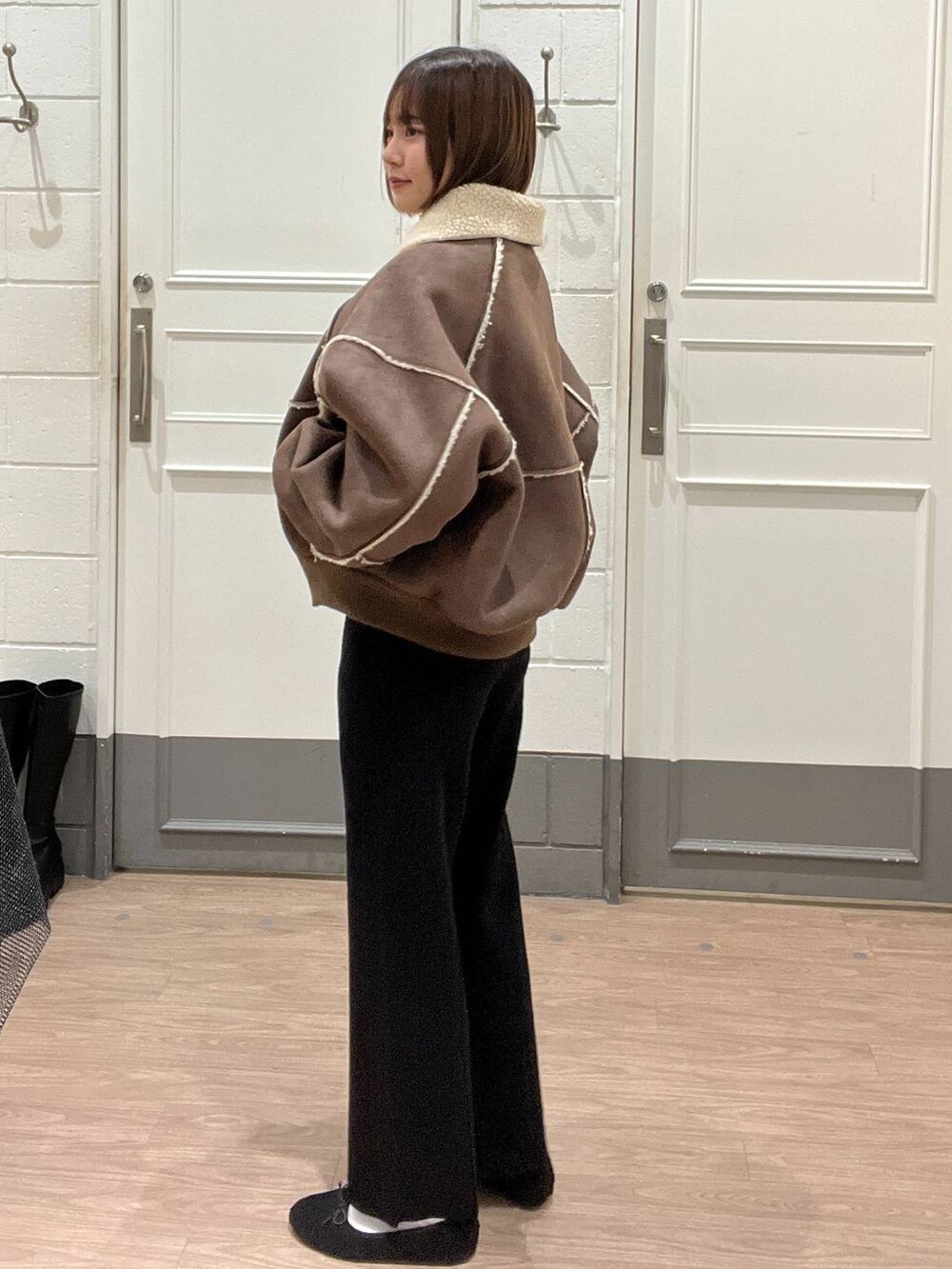 ブラウン系のブルゾン、ブラック系のその他パンツ、ブラック系のバレエシューズを着用したレディースの冬コーディネートの2枚目の写真