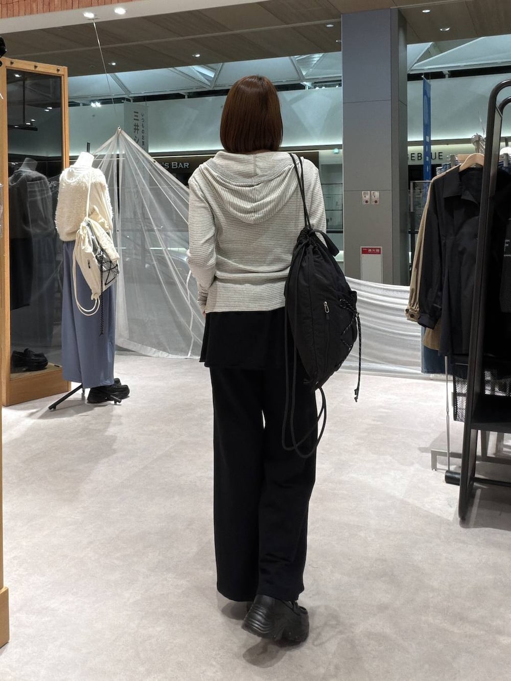 ブラック系のスウェットパンツ、グレー系のカーディガン/ボレロ、シルバー系のタンクトップを着用したレディースの秋コーディネートの3枚目の写真