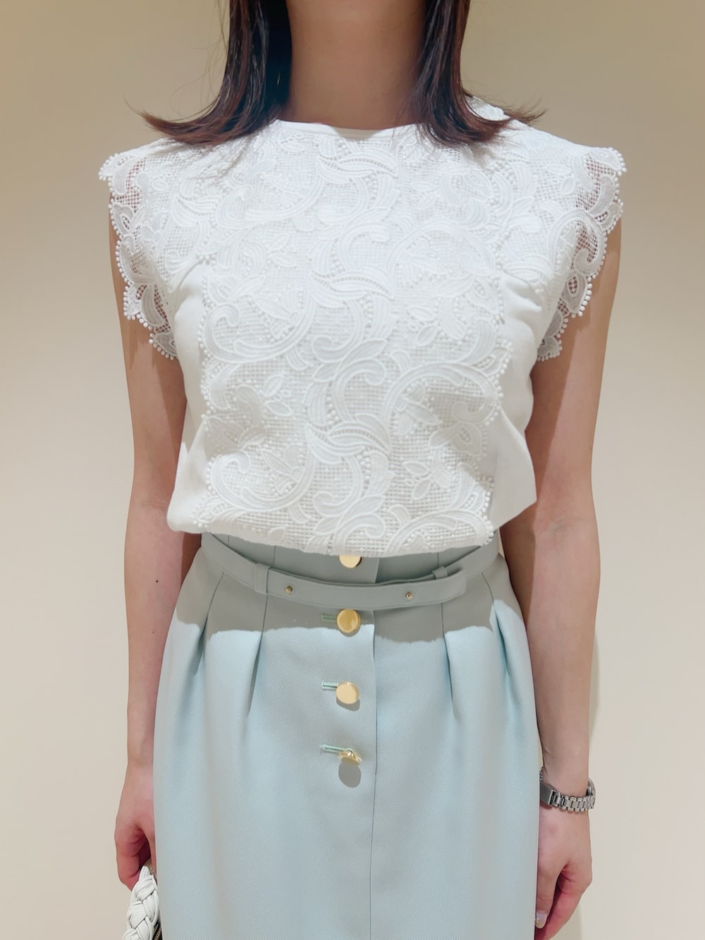 ホワイト系のニット/セーター、ホワイト系のその他トップス、グリーン系のスカートを着用したレディースの春コーディネートの8枚目の写真