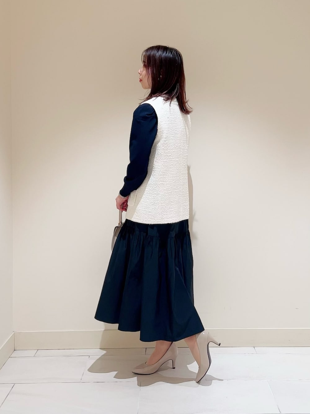 ベージュ系のトートバッグ、ホワイト系のその他アウター、ブルー系のワンピースを着用したレディースの春コーディネートの2枚目の写真