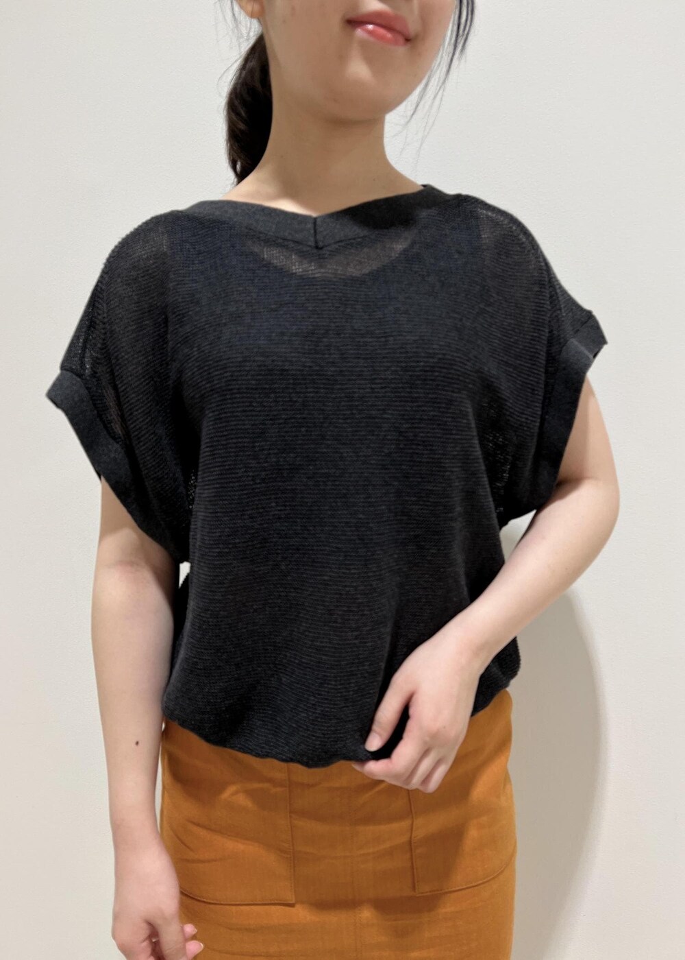 ホワイト系のハンドバッグ、ホワイト系のサンダル、オレンジ系のスカートを着用したレディースの夏コーディネートの5枚目の写真