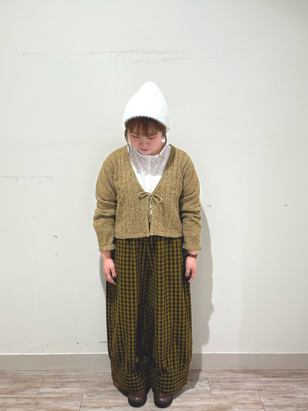 ホワイト系のシャツ/ブラウス、ベージュ系のカーディガン/ボレロ、グリーン系のパンツを着用したレディースの秋コーディネートの2枚目の写真