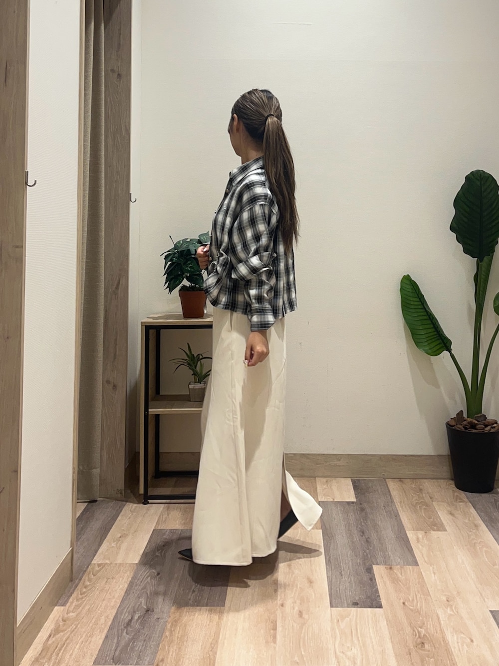 ホワイト系のスカート、ブラック系のシャツ/ブラウス、ブラック系のベルトを着用したレディースの秋コーディネートの4枚目の写真