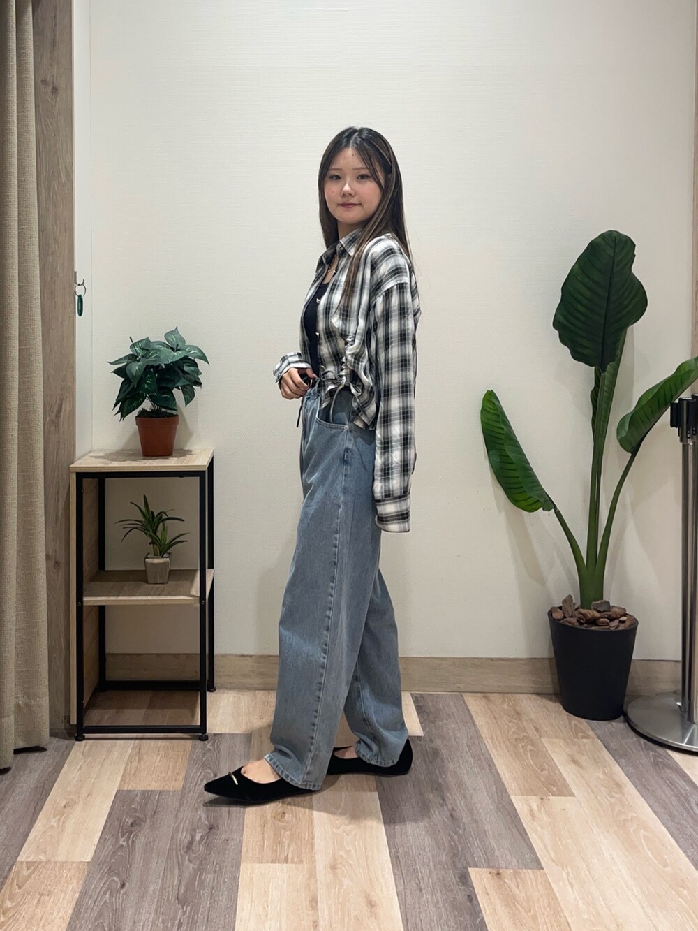 ブルー系のデニムパンツ、ブラック系のシャツ/ブラウス、ブラック系のパンプスを着用したレディースの秋コーディネートの4枚目の写真