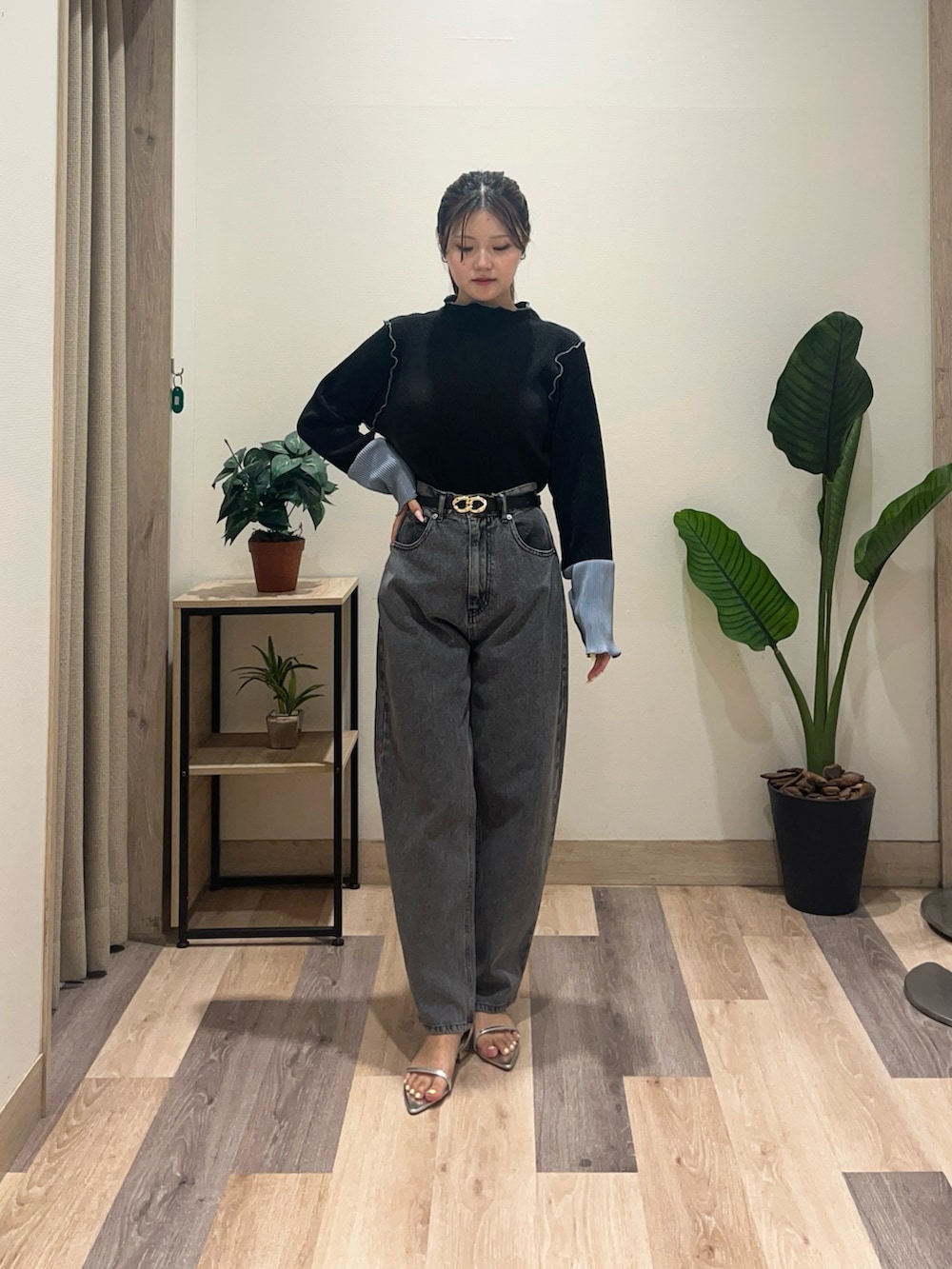 ブラック系のデニムパンツ、ブラック系のTシャツ/カットソー、ブラック系のベルトを着用したレディースの秋コーディネートの2枚目の写真