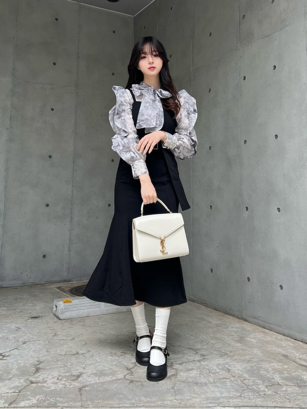 ブルー系のシャツ/ブラウス、ブラック系のワンピース、ブラック系のパンプスを着用したレディースの春コーディネートの2枚目の写真