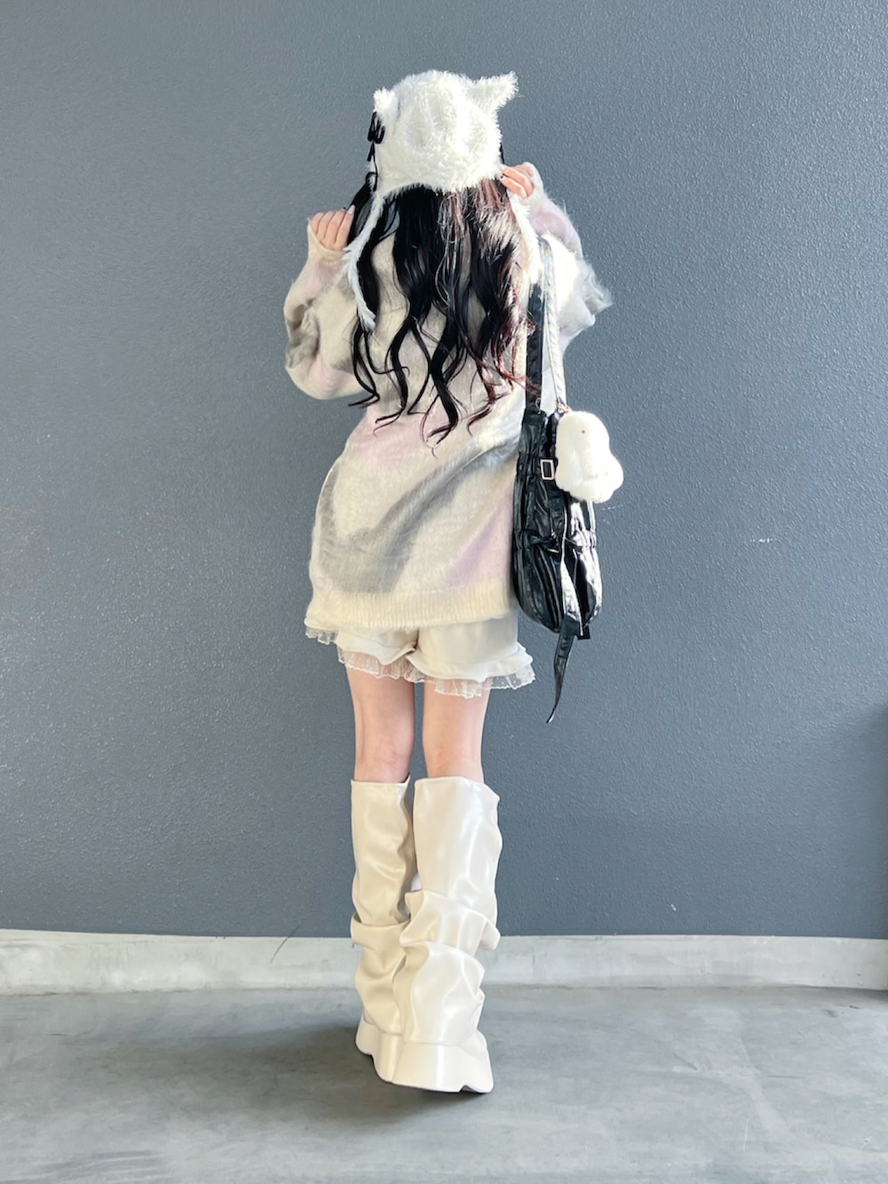 グレー系のニット/セーター、ホワイト系のその他パンツ、ホワイト系のブーツを着用したレディースの秋コーディネートの3枚目の写真