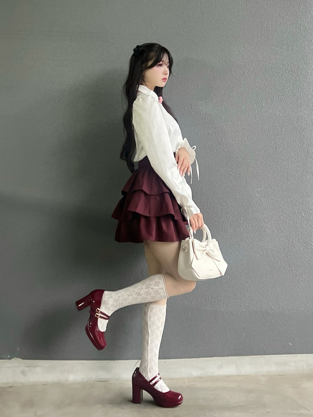 レッド系のパンプス、ホワイト系のバッグ、ホワイト系のシャツ/ブラウスを着用したレディースの秋コーディネートの4枚目の写真