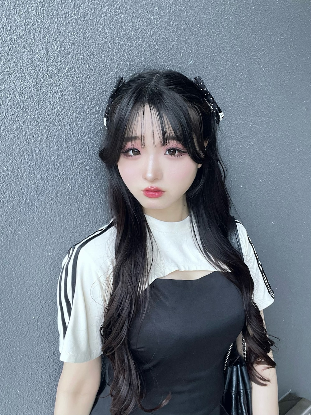 ホワイト系のTシャツ/カットソー、ブラック系のブーツ、ブラック系のショルダーバッグを着用したレディースの夏コーディネートの5枚目の写真