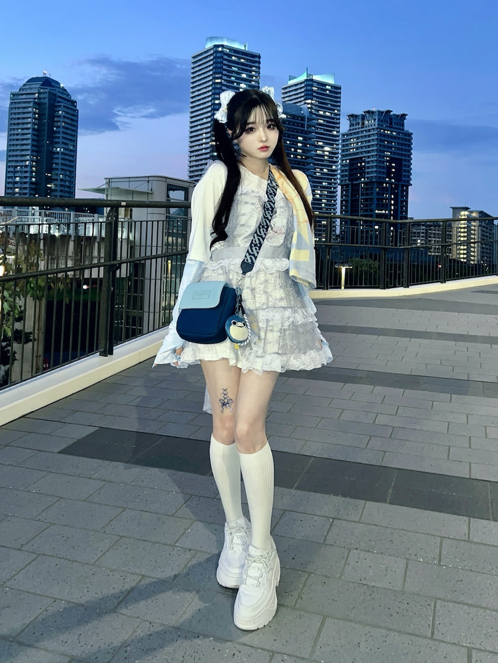 ホワイト系のスカート、ホワイト系のスニーカー、ホワイト系のTシャツ/カットソーを着用したレディースの夏コーディネートの2枚目の写真