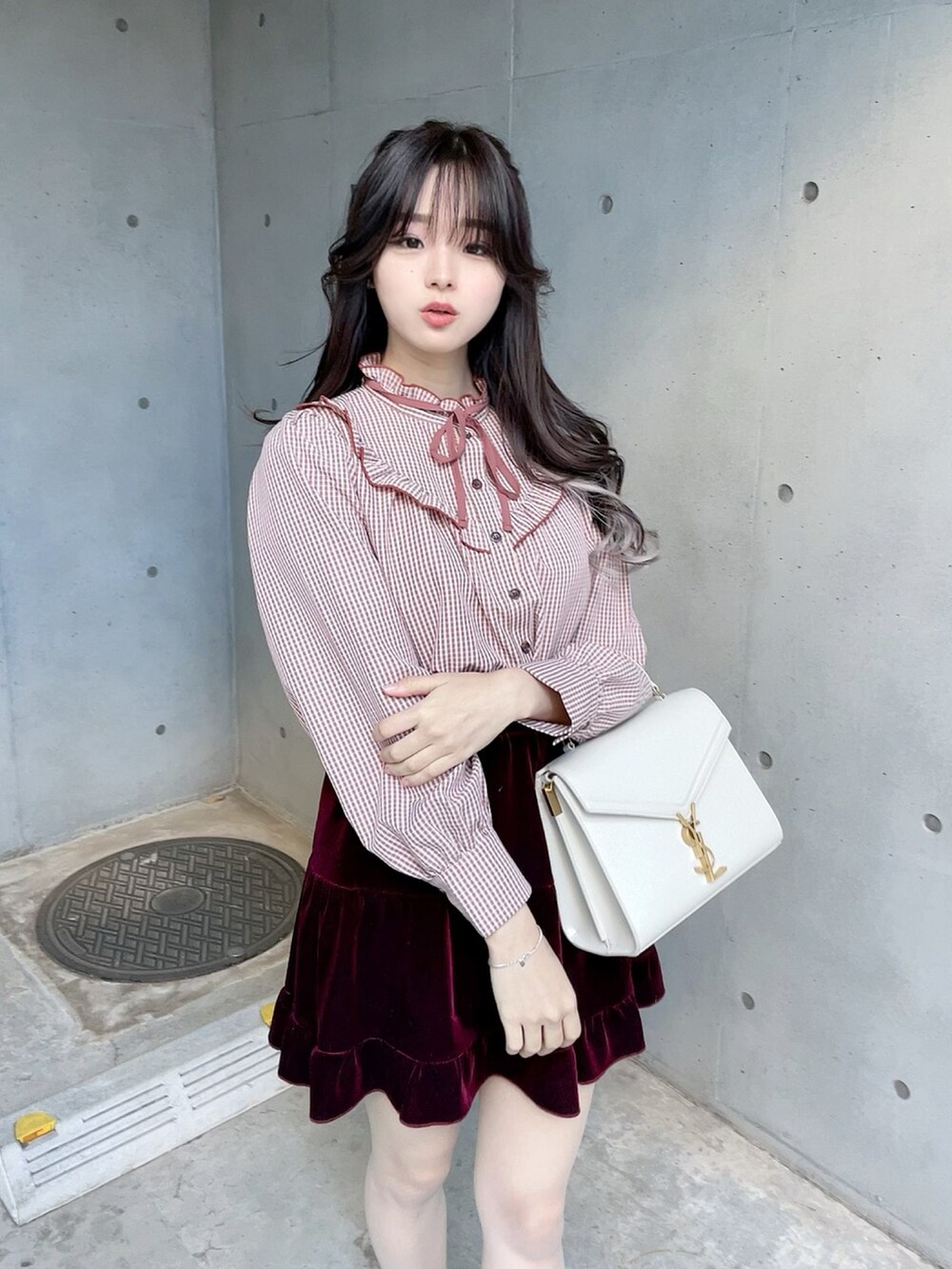 パープル系のダウンジャケット/コート、ブラック系のスカート、ピンク系のシャツ/ブラウスを着用したレディースの冬コーディネートの3枚目の写真