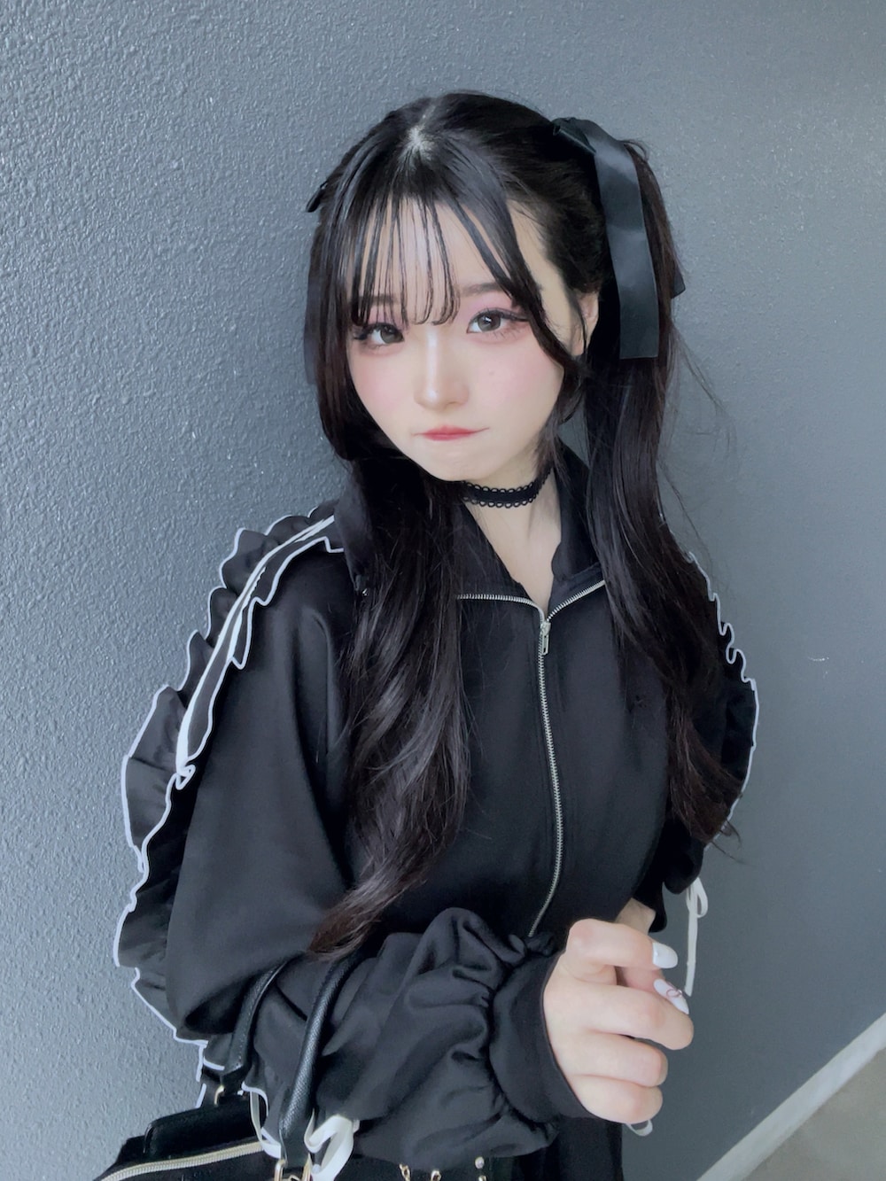 ブラック系のジャージ、ブラック系のスカート、ブラック系のバッグを着用したレディースの秋コーディネートの4枚目の写真