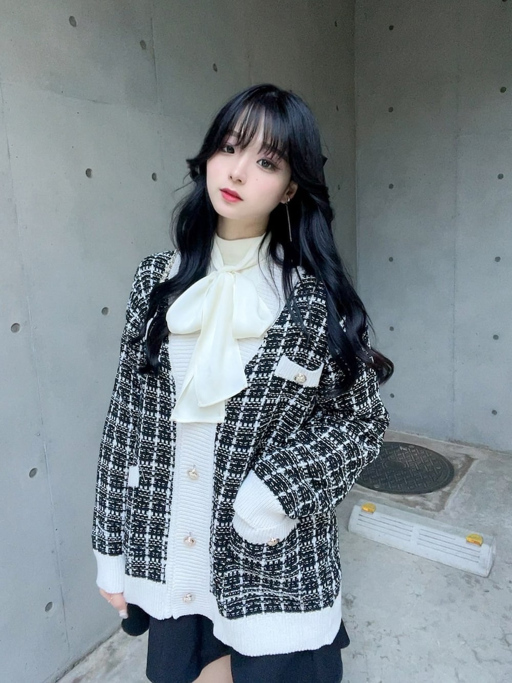 ブラック系のカーディガン/ボレロ、ホワイト系のシャツ/ブラウス、ブラック系のスカートを着用したレディースの秋コーディネートの3枚目の写真