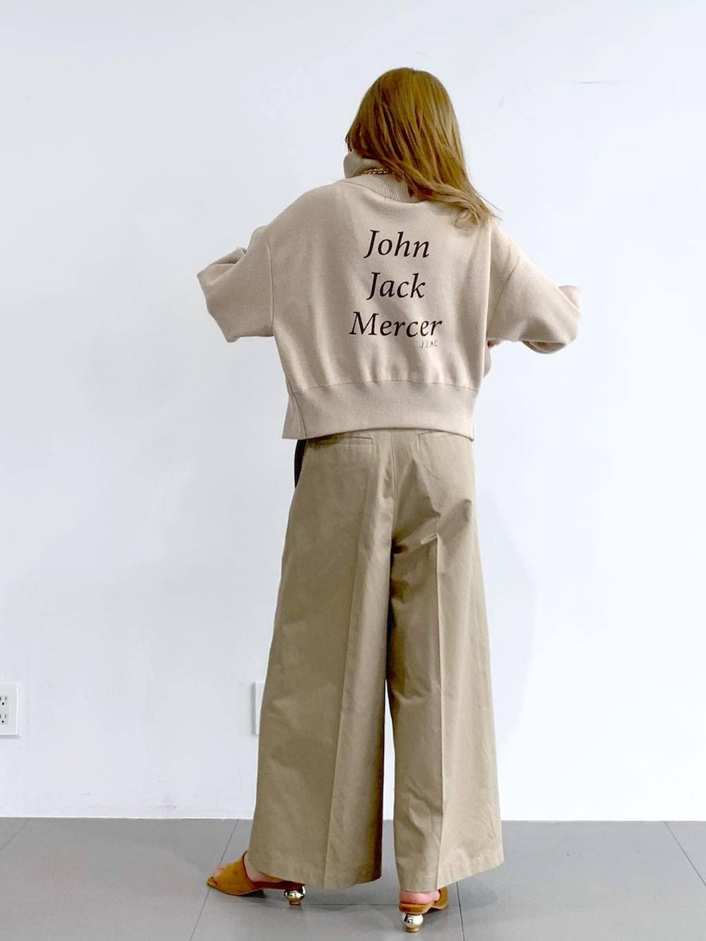 ベージュ系のチノパンツ、ベージュ系のスウェット、ブラウン系のネックレスを着用したレディースの冬コーディネートの3枚目の写真