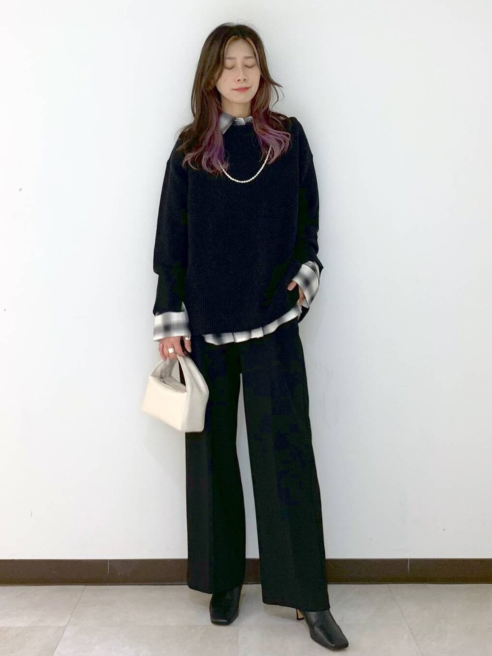 ホワイト系のハンドバッグ、グレー系のニット/セーター、ブラック系のシャツ/ブラウスを着用したレディースの冬コーディネートの3枚目の写真