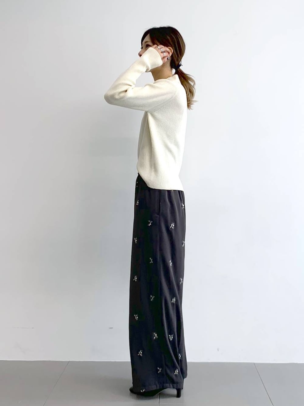 ブラック系のブーツ、ブラック系のボストンバッグ、グレー系のその他パンツを着用したレディースの冬コーディネートの3枚目の写真