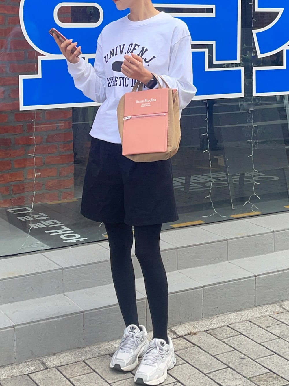 その他のバッグ、グレー系のスニーカー、ホワイト系のTシャツ/カットソーを着用したレディースの冬コーディネートの2枚目の写真