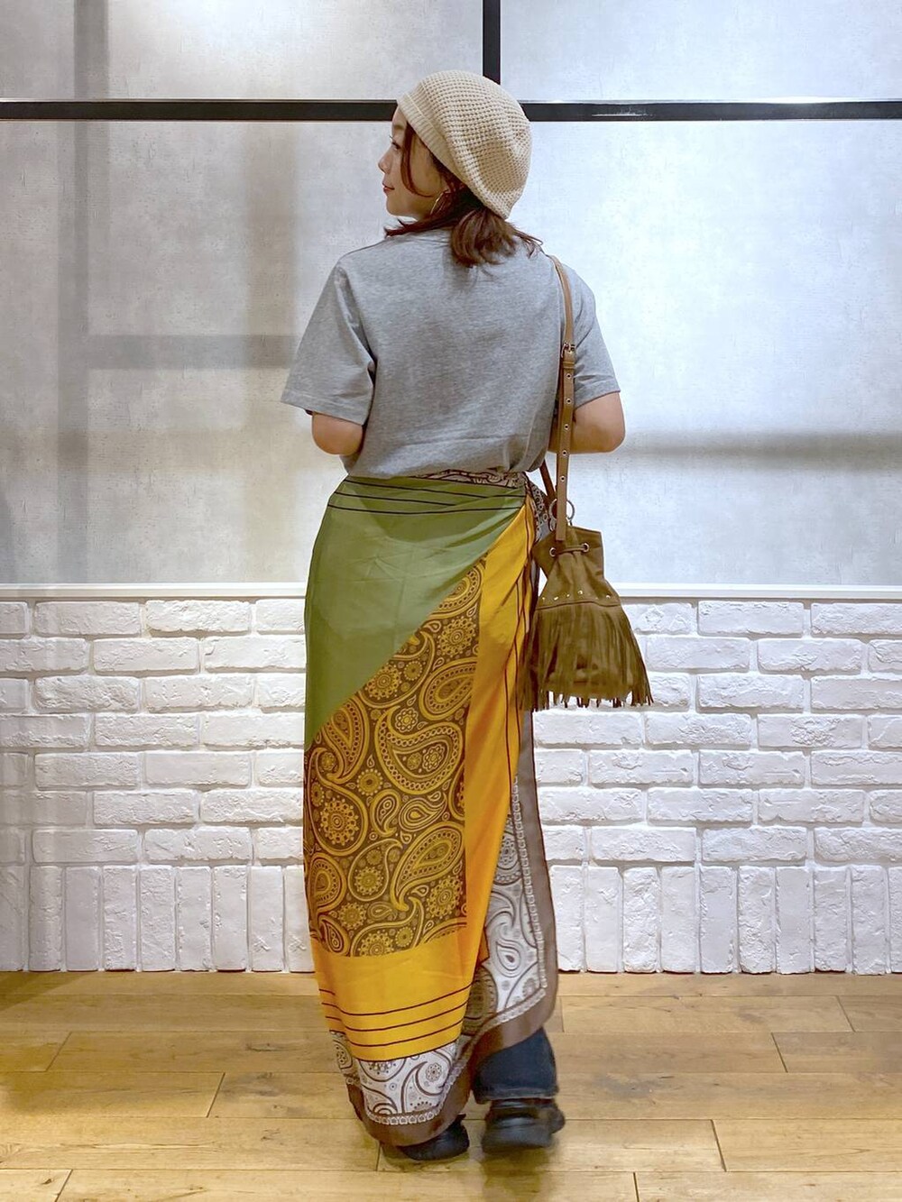 ブラック系のサンダル、ブルー系のデニムパンツ、ベージュ系のショルダーバッグを着用したレディースの夏コーディネートの7枚目の写真