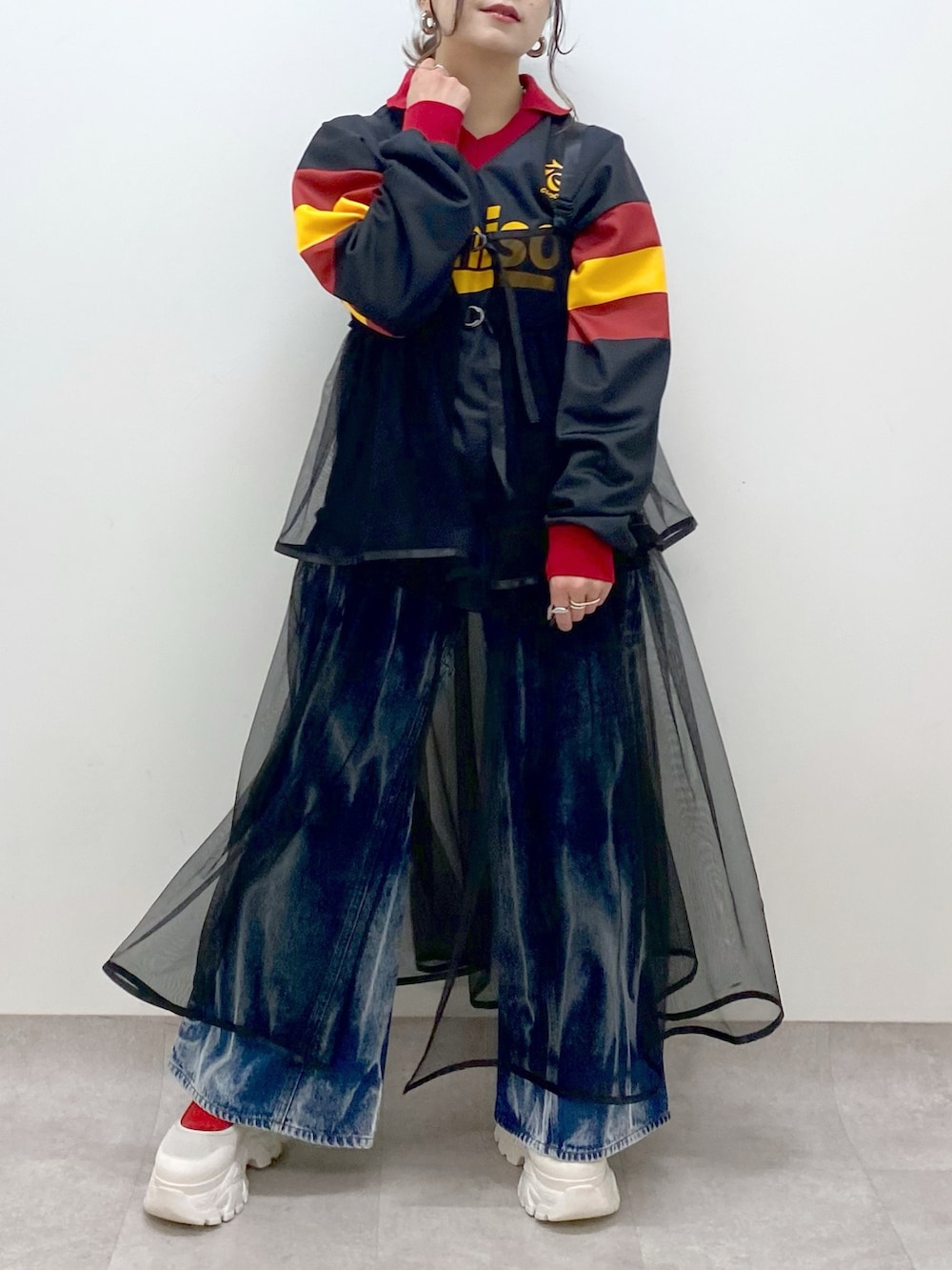 ブラック系のシャツ/ブラウス、ブラック系のワンピース、ブルー系のデニムパンツを着用したレディースの春コーディネートの3枚目の写真