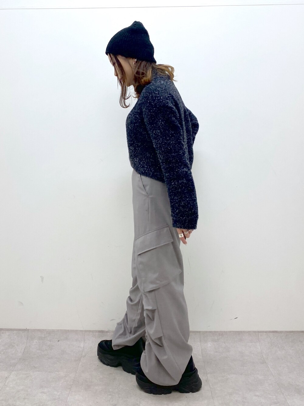 ブラック系のニット/セーター、ベージュ系のその他パンツ、ブラック系のスニーカーを着用したレディースの冬コーディネートの3枚目の写真