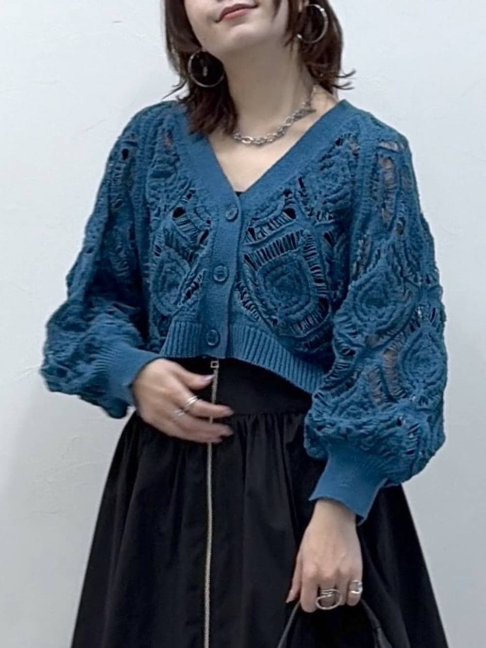 ブルー系のカーディガン/ボレロ、ブラック系のスカートを着用したレディースの春コーディネートの2枚目の写真