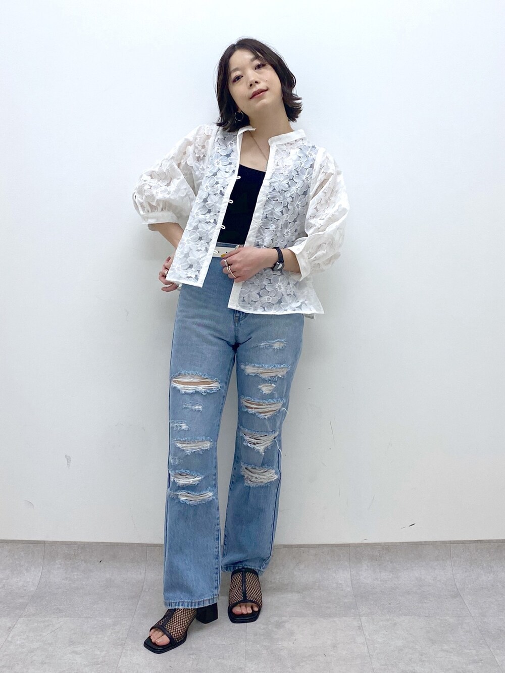 ブルー系のパンツ、ホワイト系のシャツ/ブラウス、ブラック系のトップスを着用したレディースの春コーディネートの5枚目の写真