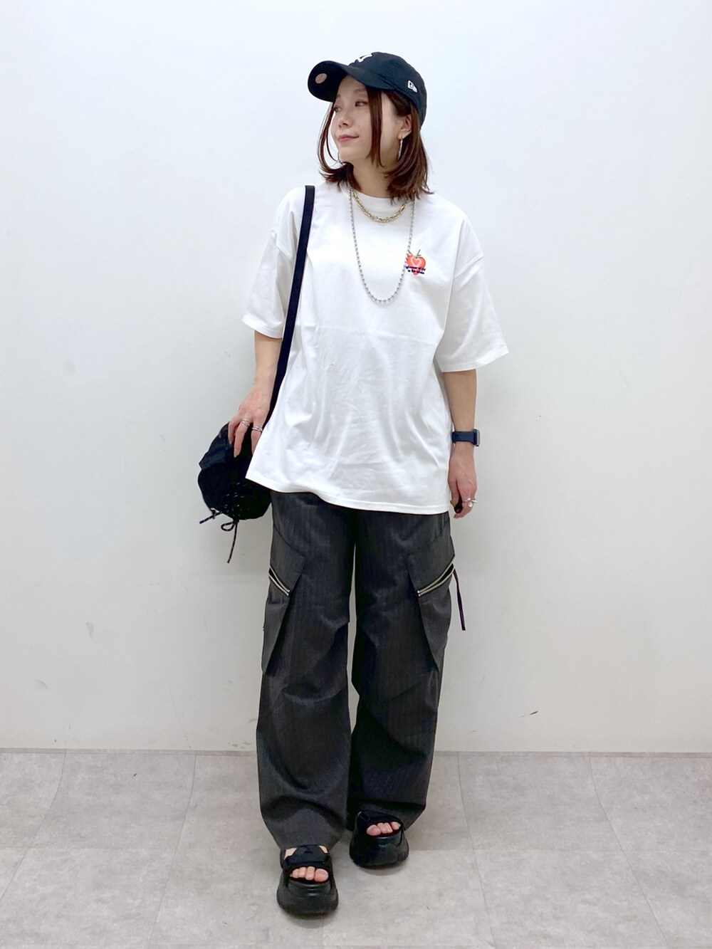ホワイト系のTシャツ/カットソー、ブラック系のボディバッグ/ウエストポーチ、グレー系のカーゴパンツを着用したレディースの春コーディネートの6枚目の写真