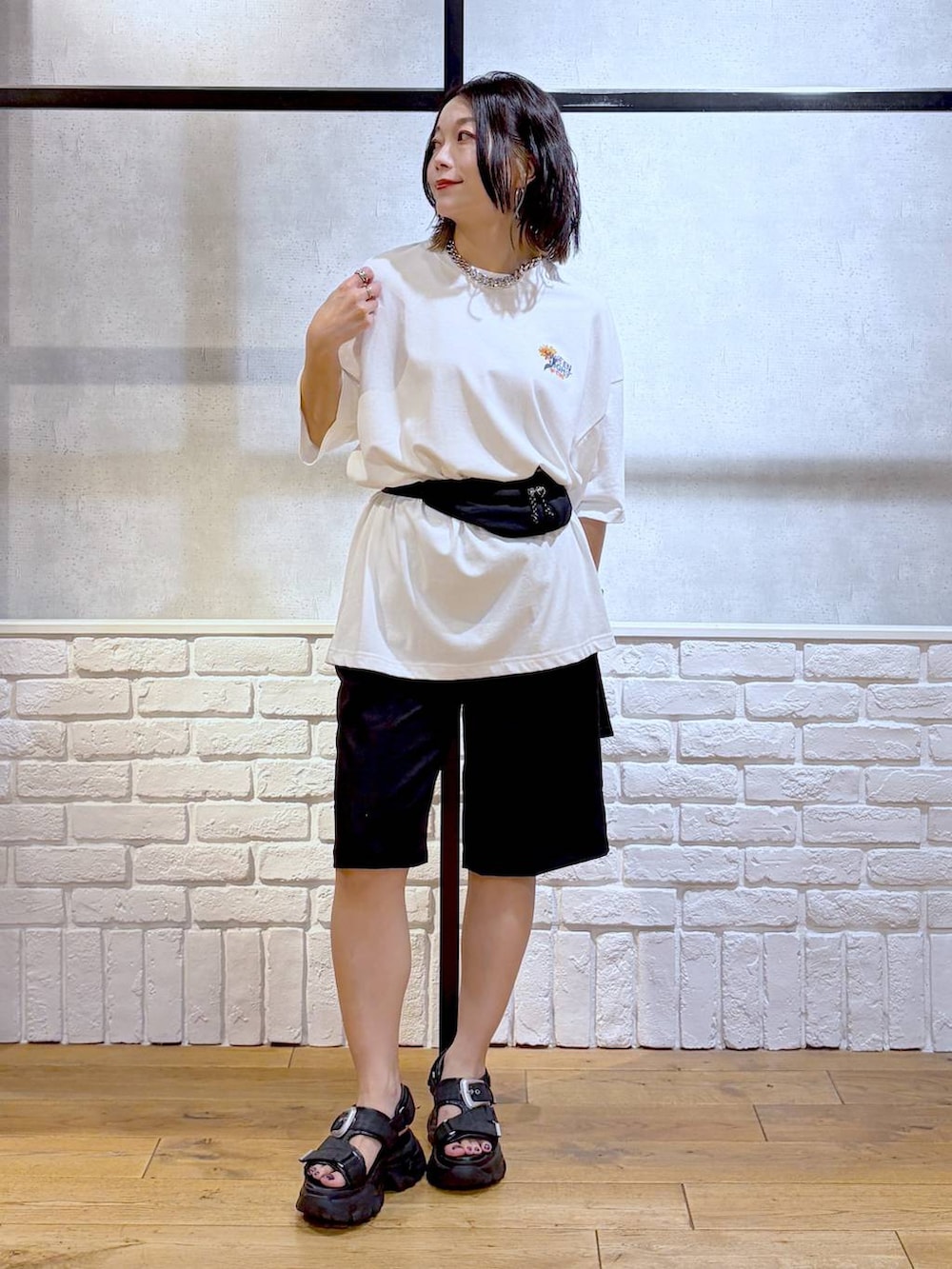 ブラック系のサンダル、ホワイト系のTシャツ/カットソー、ブラック系のその他パンツを着用したレディースの夏コーディネートの4枚目の写真