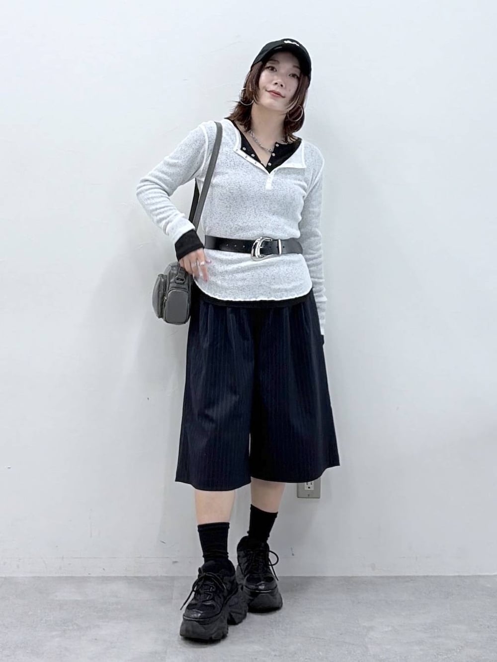 ブラック系のスニーカー、グレー系のショルダーバッグ、ブラック系のTシャツ/カットソーを着用したレディースの春コーディネートの4枚目の写真