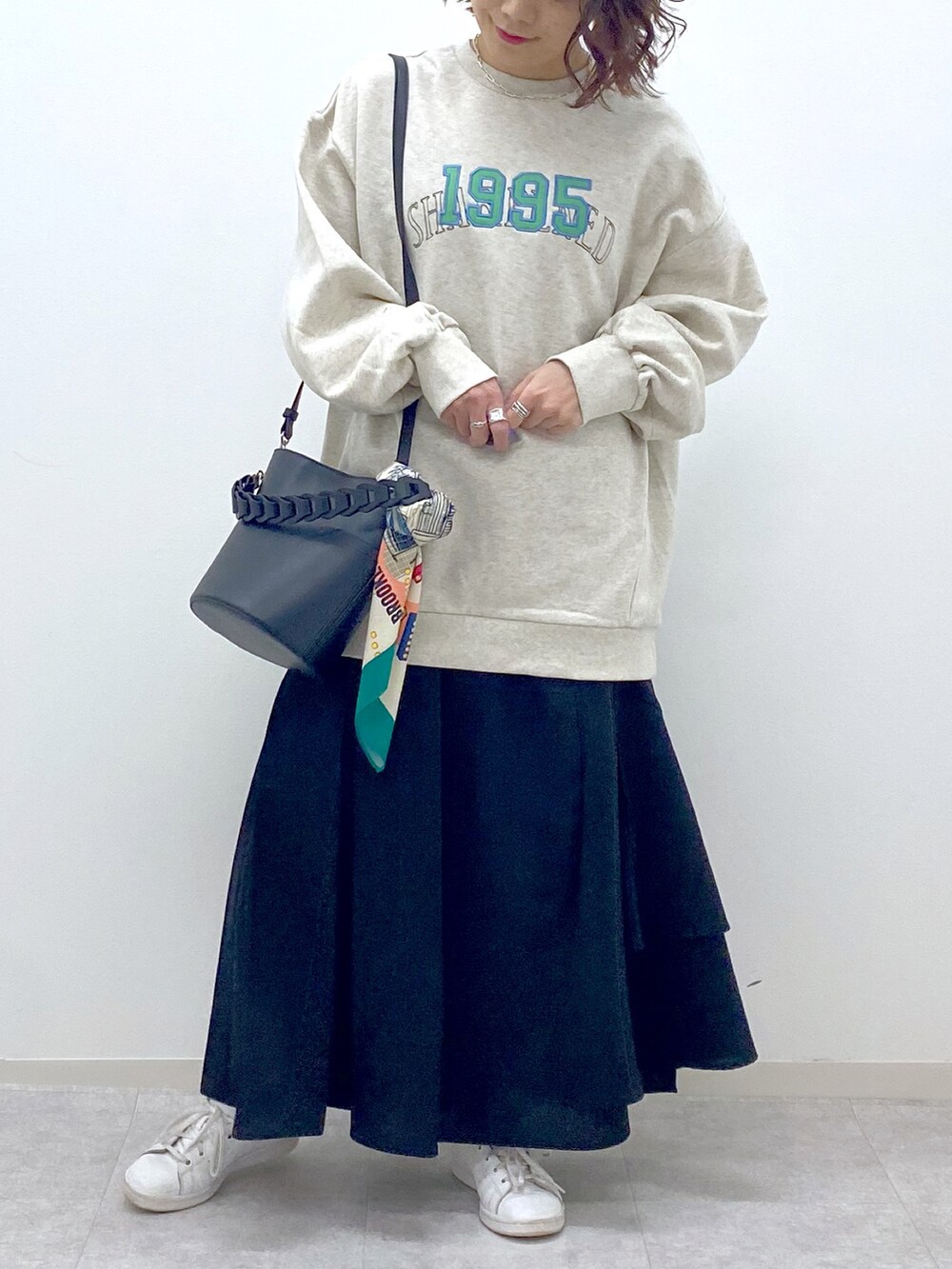 ベージュ系のスカート、ベージュ系のスウェット、ブラック系のショルダーバッグを着用したレディースの春コーディネートの5枚目の写真