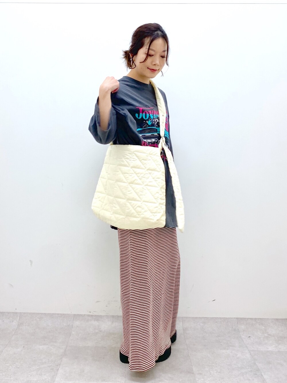 ブラウン系のワンピース、グレー系のTシャツ/カットソー、ホワイト系のショルダーバッグを着用したレディースの春コーディネートの5枚目の写真