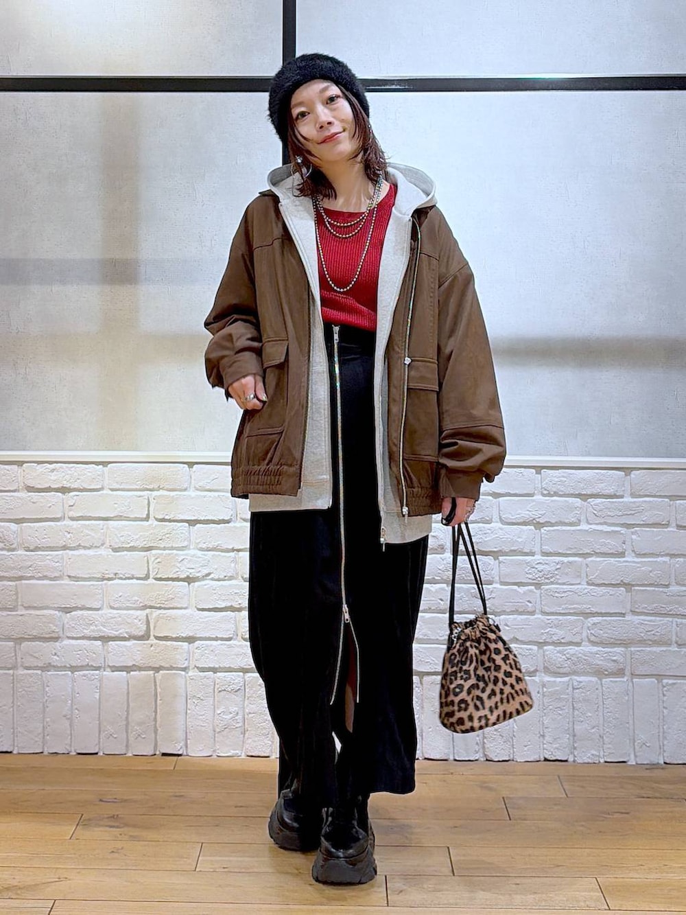 ブラック系のブーツ、ブラウン系のブルゾン、レッド系のニット/セーターを着用したレディースの冬コーディネートの9枚目の写真