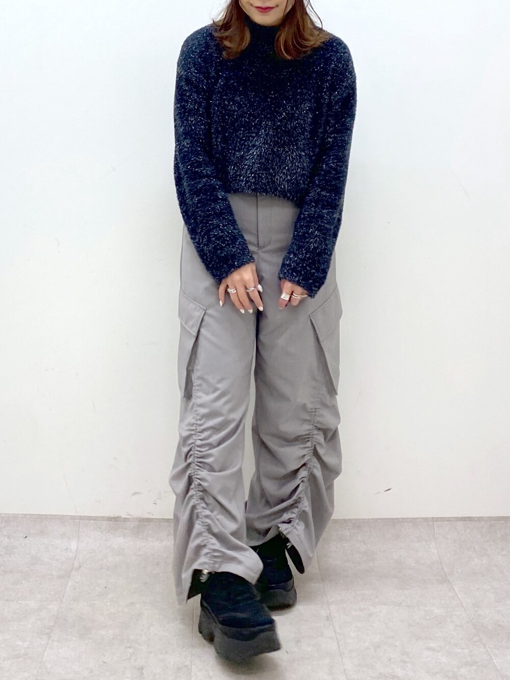 ブラック系のニット/セーター、ベージュ系のその他パンツ、ブラック系のスニーカーを着用したレディースの冬コーディネートの8枚目の写真