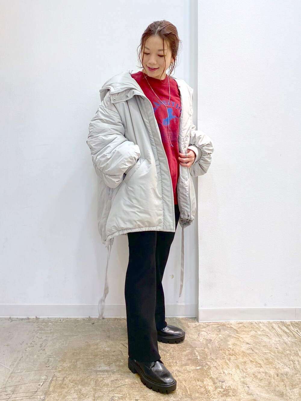 グレー系のブルゾン、ブラック系のその他パンツ、ブラック系のブーツを着用したレディースの秋コーディネートの2枚目の写真