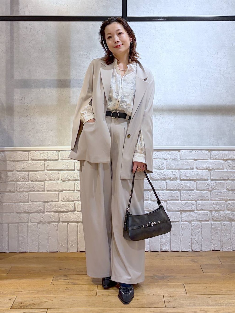 グレー系のテーラードジャケット、ベージュ系のデニムパンツ、ホワイト系のTシャツ/カットソーを着用したレディースの冬コーディネートの9枚目の写真