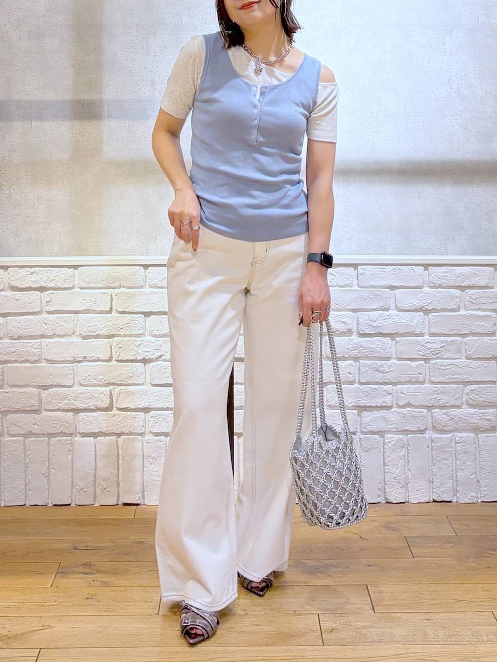 ブルー系のタンクトップ、グレー系のTシャツ/カットソー、ホワイト系のデニムパンツを着用したレディースの夏コーディネートの2枚目の写真