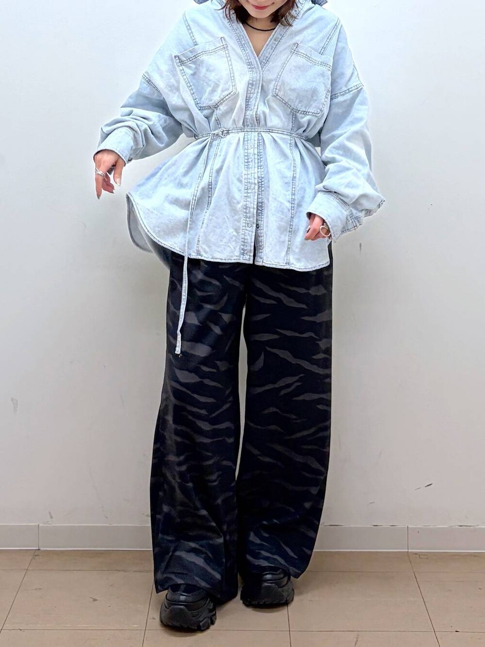 ブラック系のスニーカー、ブルー系のシャツ/ブラウス、その他のスラックスを着用したレディースの冬コーディネートの3枚目の写真