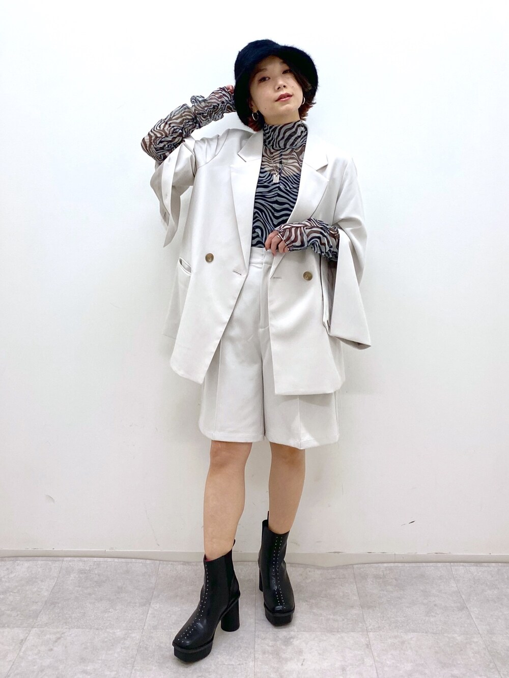 グレー系のパンツ、その他のトップス、ベージュ系のテーラードジャケットを着用したレディースの秋コーディネートの2枚目の写真