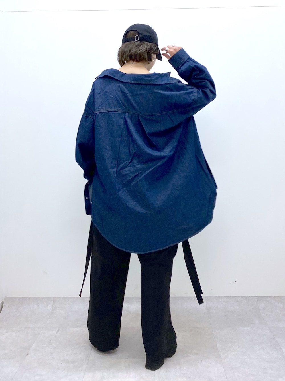 ブラック系のパンツ、ブルー系のトップス、その他のトップスを着用したレディースの春コーディネートの3枚目の写真