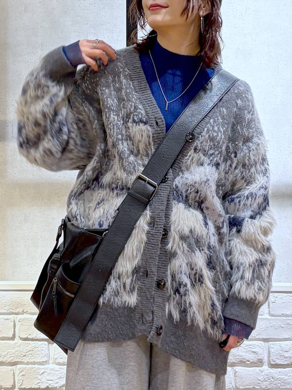 ブラック系のブーツ、グレー系のスウェットパンツ、ブラック系のボストンバッグを着用したレディースの冬コーディネートの2枚目の写真