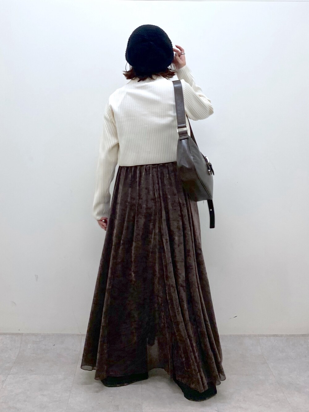 ブラウン系のワンピース、ブラウン系のショルダーバッグ、ブラック系のブーツを着用したレディースの秋コーディネートの6枚目の写真