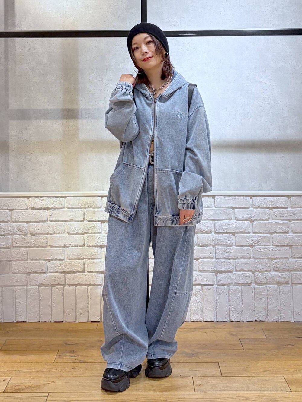 ブラック系のスニーカー、ブラック系のショルダーバッグ、ブルー系のパーカーを着用したレディースの春コーディネートの9枚目の写真