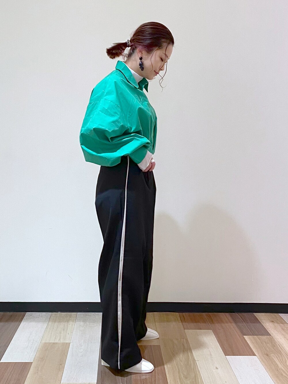 ブラック系のスラックス、ホワイト系のサンダル、ホワイト系のTシャツ/カットソーを着用したレディースの冬コーディネートの4枚目の写真